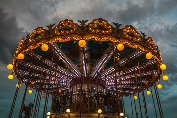 PARIS, FRANCE - AUGUST 30, 2015: Old French carousel in a holiday park at night summer time. - 100492070