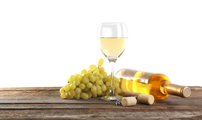 Wine and grape on wooden table against light background