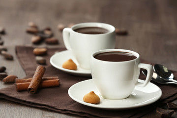Cacao with sweets and cinnamon on cutting board