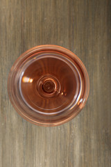 Glass of wine on wooden table. Top view