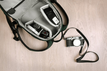 Photographer's equipment on a light wooden background