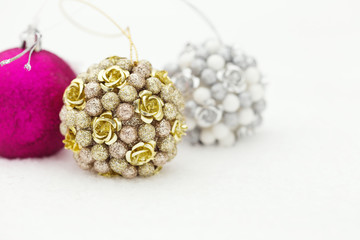 Three decorated christmas balls in the real snow. Winter outdoor