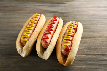 Tasty hotdogs on wooden background