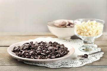 Chocolate morsels on wooden background