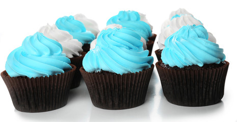 Fresh delicious cupcakes in a row isolated on white background