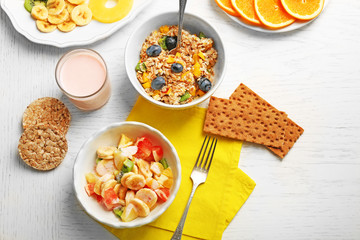 Tasty oatmeal and fruit salad on wooden background. Healthy eating concept.