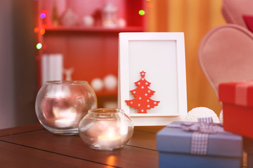 Colourful gift boxes on wooden table in the room, close up