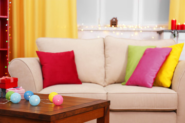 Colourful decorated interior. Comfortable living room, table with Christmas decorations on it is close up