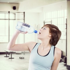 Composite image of pretty brunette drinking water