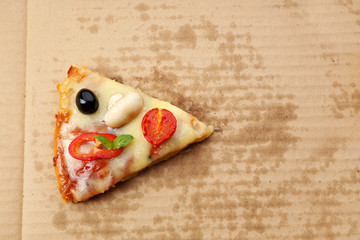 Slice of tasty pizza on carton, close up