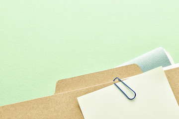 Office supplies. Stack of files. On green background with copy space