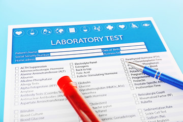 Blood in test tubes, pen and investigation form on the table
