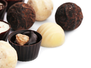 Assorted collection of chocolate candies and sweets, isolated on white, close-up