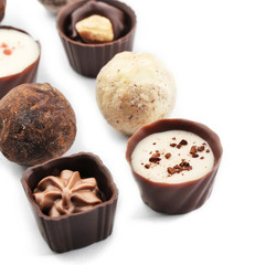 Assorted collection of chocolate candies and sweets, isolated on white