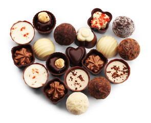 Obraz premium Heart-shaped collection of chocolate candies and sweets, isolated on white