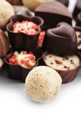 Assorted collection of chocolate candies and sweets, on white background, close-up