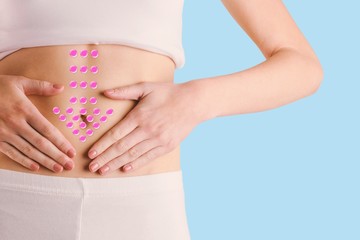 Composite image of slim woman touching her belly