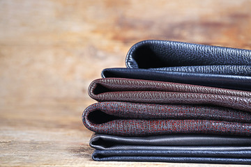 Pile of leather fabric on the wooden table