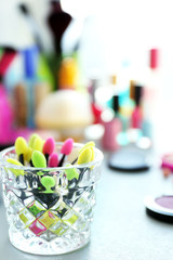 Colored cosmetic sponge brushes on a table, close up