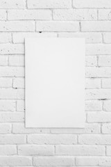 white board on white brick wall