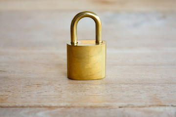 Golden padlock on wood background