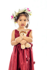 Beautiful little girl in red dress with Teddy Bear isolated on white background