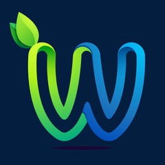 Fototapeta premium W letter with green leaves and water waves.