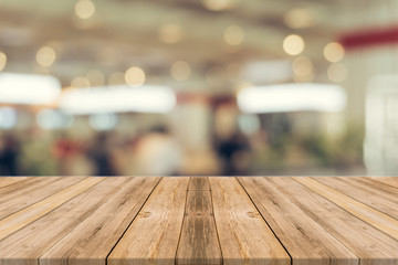 Wooden board empty table in restaurant blurred background. Perspective brown wood over blur in...