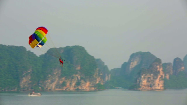 parasailing over limestone mountain islands, Halong Bay, Vietnam