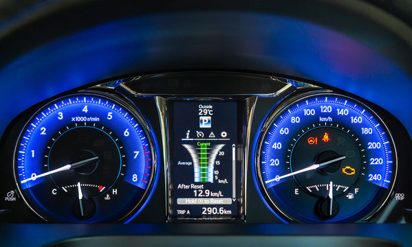 Modern car instrument panel. Blue illuminated display. Car dashboard.