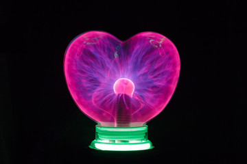 Plasma ball heart glowing in the dark