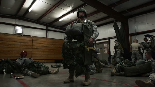 Man Standing in a Building Preparing for Parachute Training