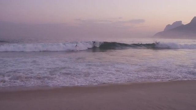 Sunset surfers with Rio, Brazil in background