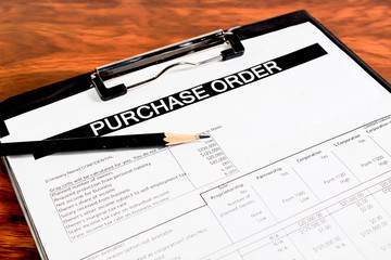 Purchase order form with pencil on wooden table selective focus 