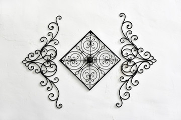 Decorative wrought iron hanging on the white wall