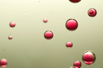 Red wine bubbles soars in a golden glass of wine