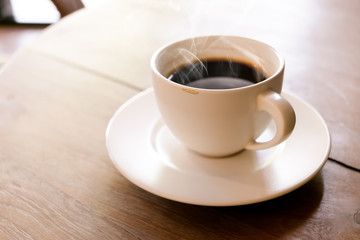 Cup of coffee on wooden table