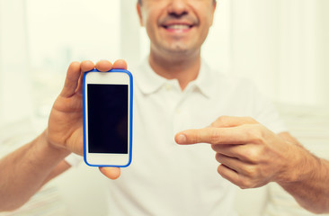 close up of happy man with smartphone at home