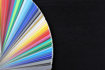 Plastic color Swatch on the black wooden table