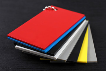 Plastic color Swatch on the black wooden table