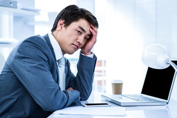 Tired businessman holding his head