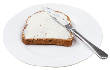 rye bread with Cheese spread and knife on plate