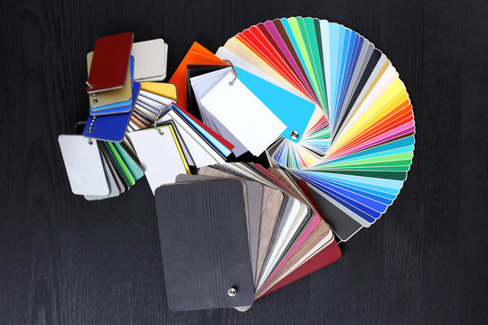 Plastic and wood sample color on the black wooden table