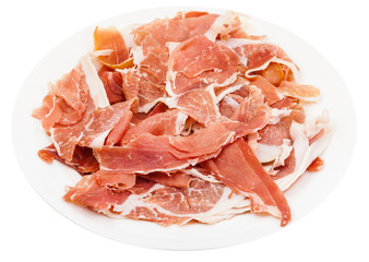 thin sliced dry-cured ham on white plate isolated