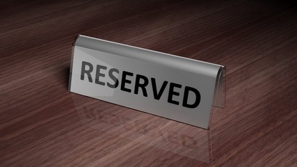Silver glossy reservation sign on wooden surface with reflection