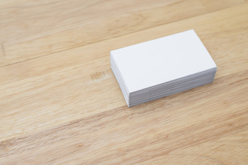 blank business cards stack up on wooden table