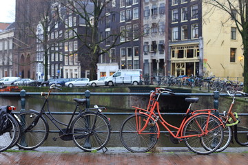 Fototapeta na wymiar Bicycles lining a bridge over the canals of Amsterdam, Netherlands