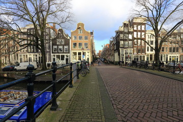 Fototapeta premium Beautiful view of Amsterdam canals with bridge and typical dutch houses. Holland