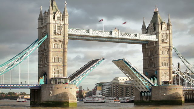 Bascules raise on Tower Bridge in London, England.