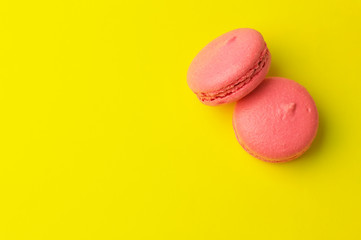 Pink macaroons on yellow background